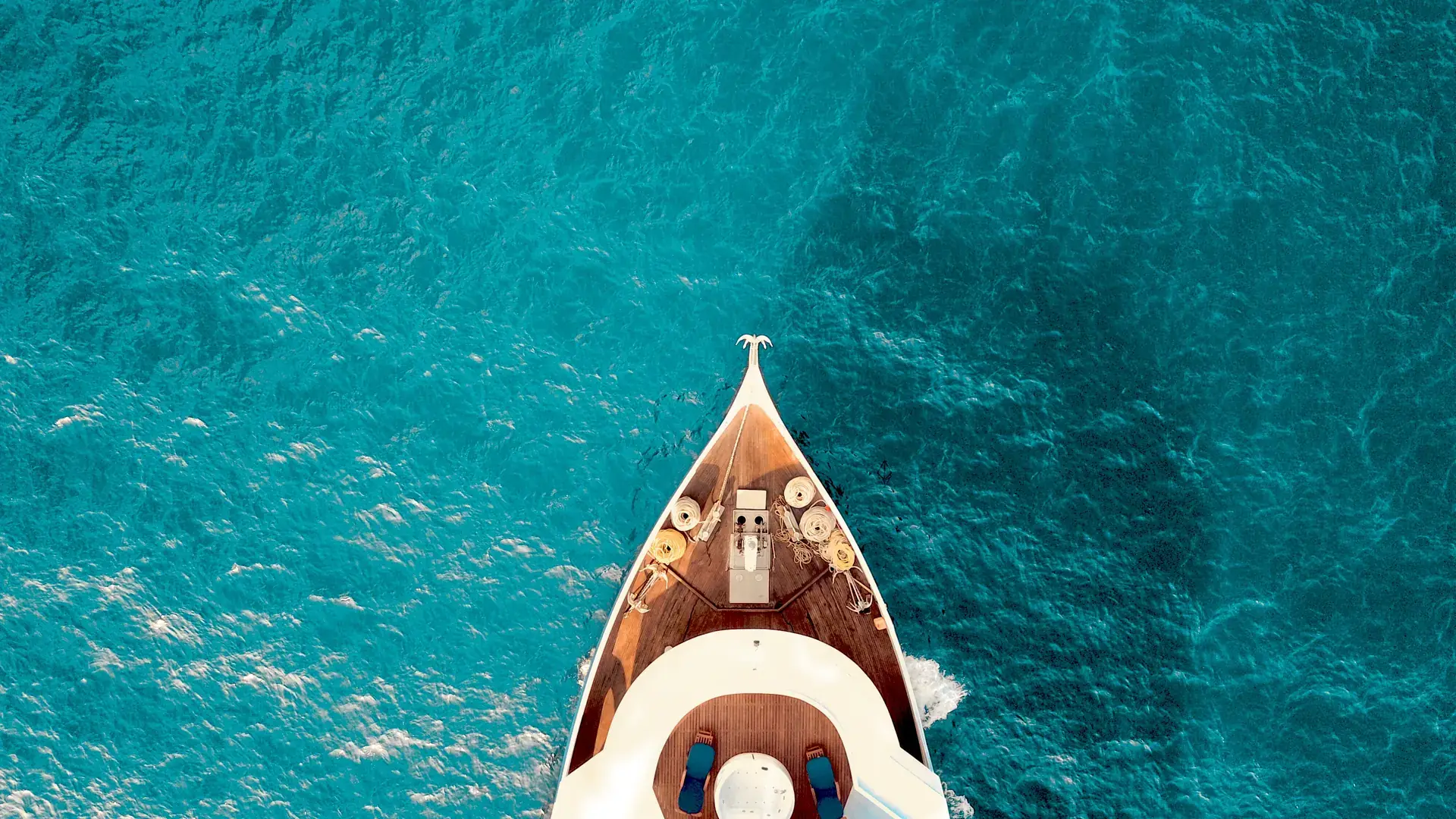 Yacht sailing through clear tropical water
